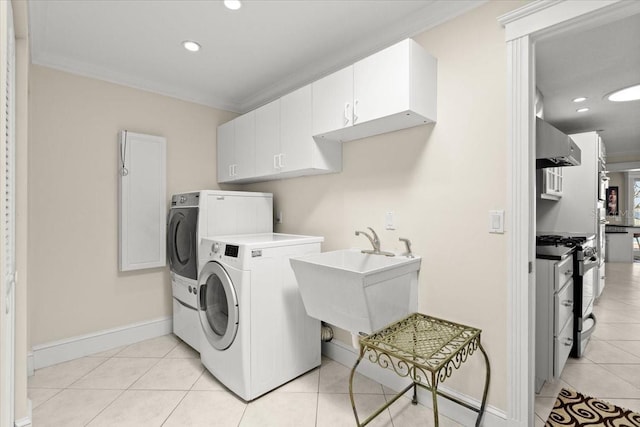 2924 River Point Dr, Daytona Beach, FL 32118 - washroom featuring crown molding, washer and clothes dryer, light tile patterned flooring, and a sink