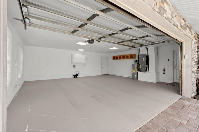 2924 River Point Dr, Daytona Beach, FL 32118 - garage with electric water heater, heating unit, and a garage door opener