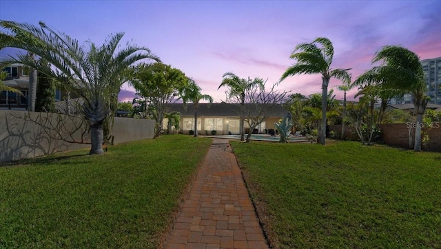 2924 River Point Dr, Daytona Beach, FL 32118 - rear view of house featuring fence private yard and a lawn