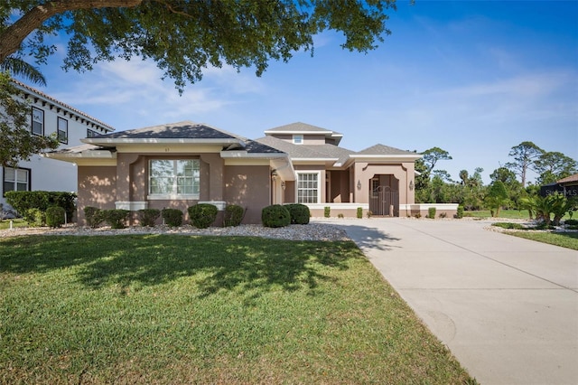 65 Heron Dr, Palm Coast, FL 32137 - view of front of property with a front yard, driveway, and stucco siding