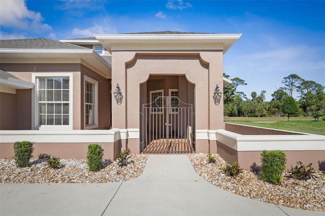 65 Heron Dr, Palm Coast, FL 32137 - doorway to property with a gate and stucco siding