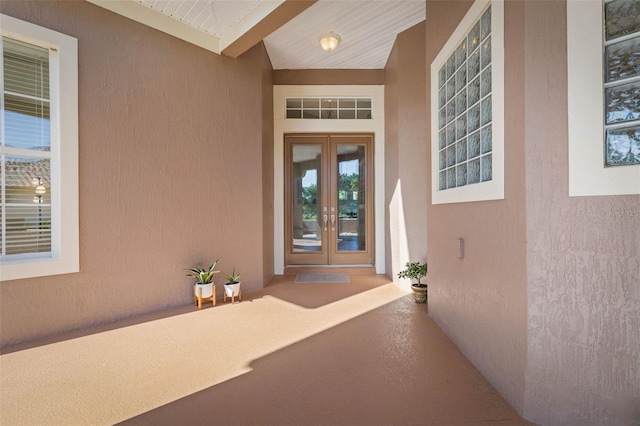 65 Heron Dr, Palm Coast, FL 32137 - doorway to property featuring french doors, visible vents, and stucco siding