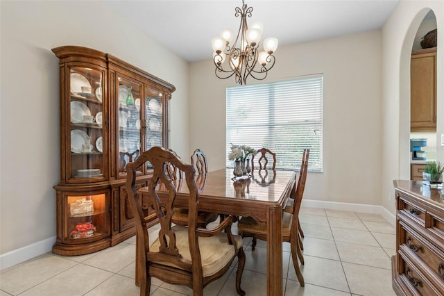 65 Heron Dr, Palm Coast, FL 32137 - dining area featuring a chandelier, arched walkways, a healthy amount of sunlight, and light tile patterned flooring