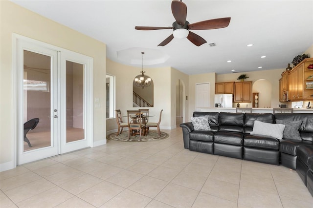 65 Heron Dr, Palm Coast, FL 32137 - living area featuring light tile patterned floors, french doors, visible vents, arched walkways, and ceiling fan with notable chandelier
