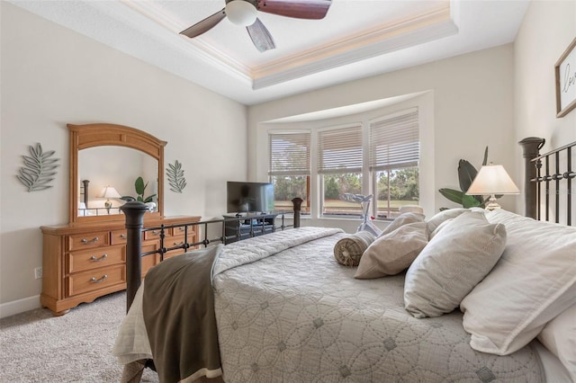 65 Heron Dr, Palm Coast, FL 32137 - bedroom with a raised ceiling, crown molding, a ceiling fan, and light carpet