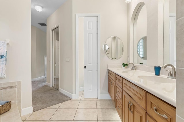 65 Heron Dr, Palm Coast, FL 32137 - bathroom featuring tile patterned flooring, double vanity, visible vents, and a sink