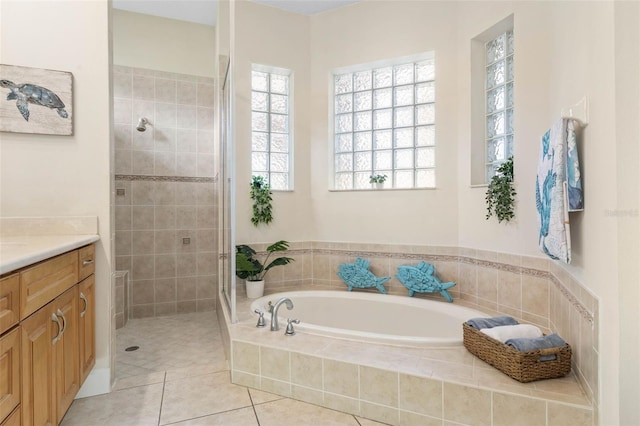 65 Heron Dr, Palm Coast, FL 32137 - full bath featuring tile patterned floors, vanity, a bath, and a stall shower