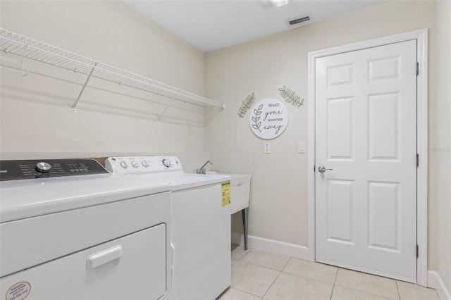 65 Heron Dr, Palm Coast, FL 32137 - washroom with baseboards, visible vents, laundry area, and washing machine and clothes dryer