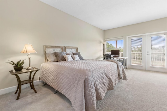 65 Heron Dr, Palm Coast, FL 32137 - bedroom with access to outside, light colored carpet, lofted ceiling, french doors, and baseboards