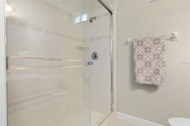 65 Heron Dr, Palm Coast, FL 32137 - bathroom with toilet, a stall shower, and baseboards