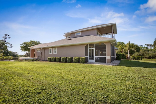 65 Heron Dr, Palm Coast, FL 32137 - rear view of house featuring a balcony, a sunroom, a lawn, and stucco siding