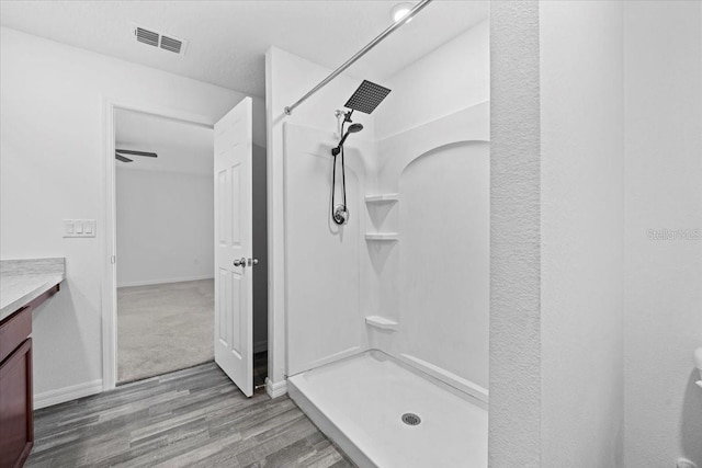 10 Post Oak Ln, Palm Coast, FL 32164 - bathroom with wood finished floors, a stall shower, vanity, and baseboards