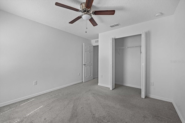 10 Post Oak Ln, Palm Coast, FL 32164 - unfurnished bedroom with a textured ceiling, carpet, a closet, baseboards, and ceiling fan