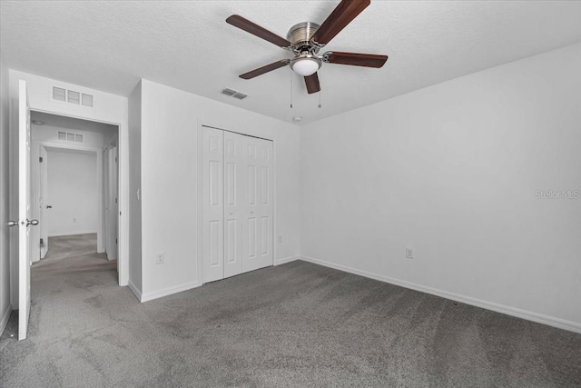 10 Post Oak Ln, Palm Coast, FL 32164 - unfurnished bedroom featuring carpet floors, a closet, a textured ceiling, baseboards, and a ceiling fan