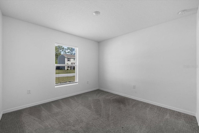 10 Post Oak Ln, Palm Coast, FL 32164 - empty room with dark carpet, baseboards, and a smoke detector