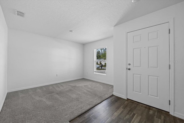 10 Post Oak Ln, Palm Coast, FL 32164 - entrance foyer featuring dark wood finished floors, a textured ceiling, and baseboards