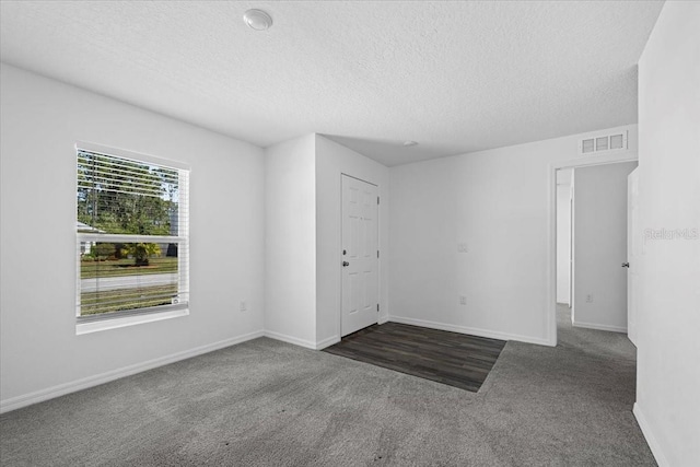 10 Post Oak Ln, Palm Coast, FL 32164 - carpeted empty room with a textured ceiling and baseboards
