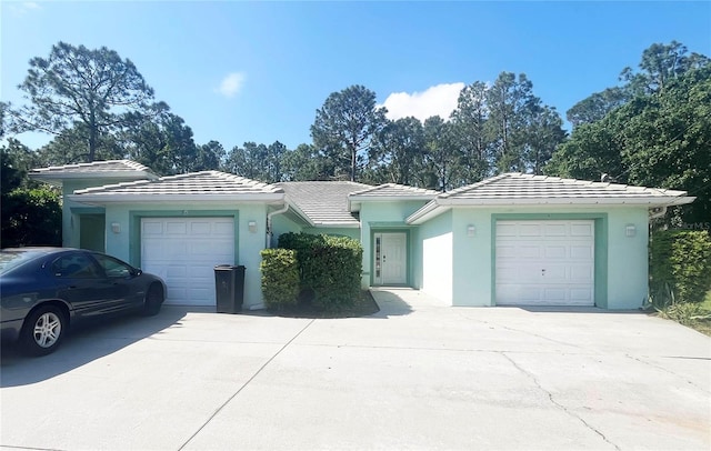 3 Frank Pl, Palm Coast, FL 32137 - ranch-style house with a garage, stucco siding, driveway, and a tile roof