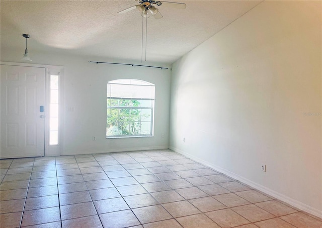 3 Frank Pl, Palm Coast, FL 32137 - unfurnished room featuring light tile patterned floors, baseboards, a ceiling fan, and a textured ceiling