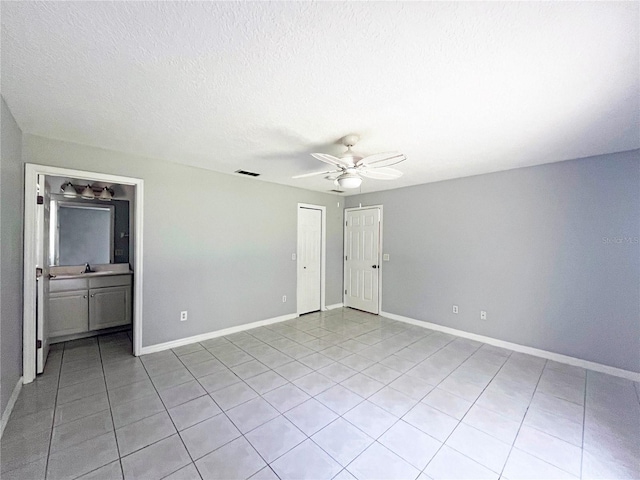3 Frank Pl, Palm Coast, FL 32137 - unfurnished room with light tile patterned floors, visible vents, baseboards, a sink, and ceiling fan