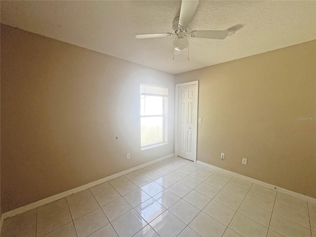3 Frank Pl, Palm Coast, FL 32137 - empty room with baseboards, a ceiling fan, light tile patterned flooring, and a textured ceiling
