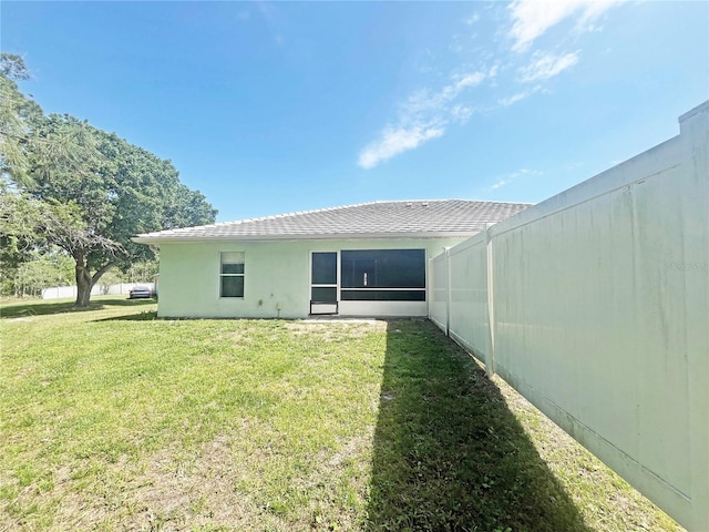 3 Frank Pl, Palm Coast, FL 32137 - back of house featuring roof with shingles, stucco siding, and a lawn