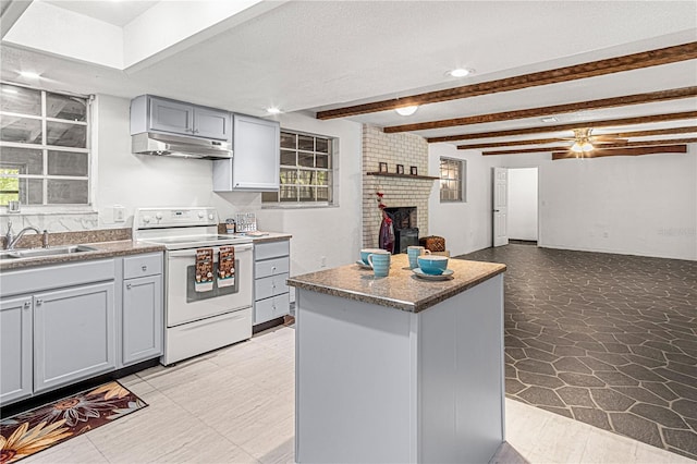 600 10th St, Daytona Beach, FL 32117 - kitchen with a center island, gray cabinetry, under cabinet range hood, a sink, and white range with electric cooktop
