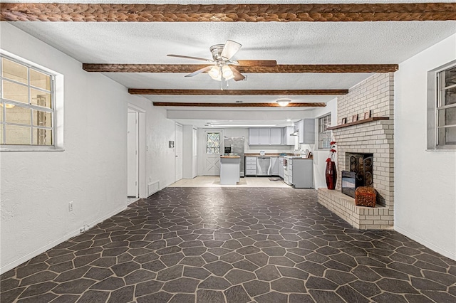 600 10th St, Daytona Beach, FL 32117 - unfurnished living room with stone flooring, ceiling fan, beam ceiling, and a textured ceiling
