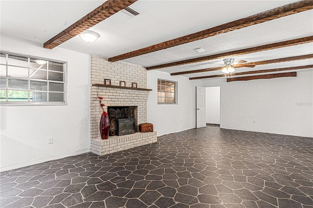 600 10th St, Daytona Beach, FL 32117 - unfurnished living room featuring baseboards, a fireplace, a ceiling fan, stone floors, and beam ceiling