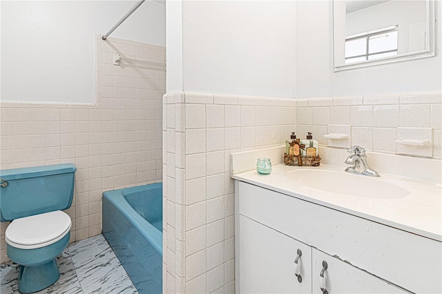 600 10th St, Daytona Beach, FL 32117 - bathroom featuring toilet, tile walls, vanity, a wainscoted wall, and marble finish floor