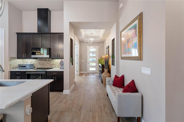 816 Creekwood Dr, Ormond Beach, FL 32174 - kitchen with tasteful backsplash, a sink, light wood finished floors, baseboards, and appliances with stainless steel finishes