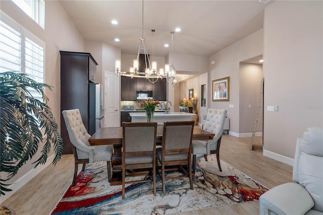 816 Creekwood Dr, Ormond Beach, FL 32174 - dining area featuring light wood-type flooring, baseboards, recessed lighting, and a chandelier