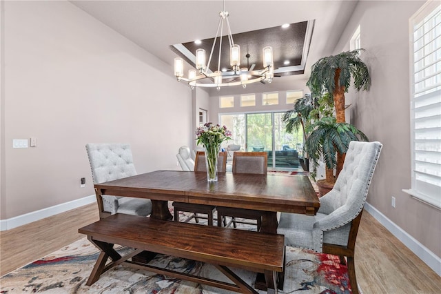 816 Creekwood Dr, Ormond Beach, FL 32174 - dining room with light wood finished floors, baseboards, and a chandelier