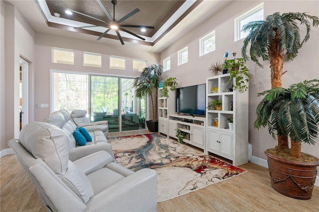 816 Creekwood Dr, Ormond Beach, FL 32174 - living room with a towering ceiling, light wood finished floors, ornamental molding, baseboards, and ceiling fan
