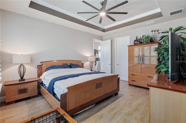 816 Creekwood Dr, Ormond Beach, FL 32174 - bedroom with a tray ceiling, visible vents, and light wood-style flooring