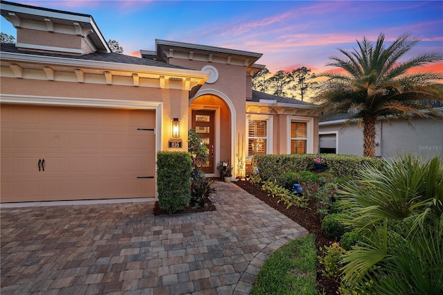 816 Creekwood Dr, Ormond Beach, FL 32174 - mediterranean / spanish-style home featuring a garage, driveway, and stucco siding