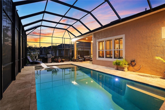 816 Creekwood Dr, Ormond Beach, FL 32174 - pool at dusk with an outdoor pool, a patio area, and glass enclosure