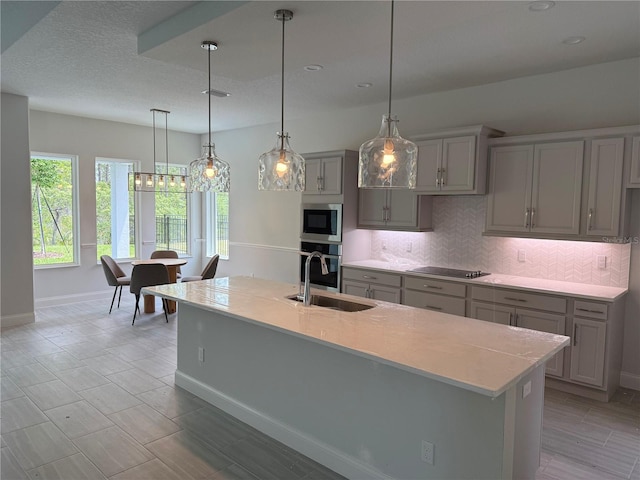 1665 Lake Reserve Dr, Deland, FL 32724 - kitchen featuring gray cabinetry, a sink, appliances with stainless steel finishes, decorative backsplash, and baseboards