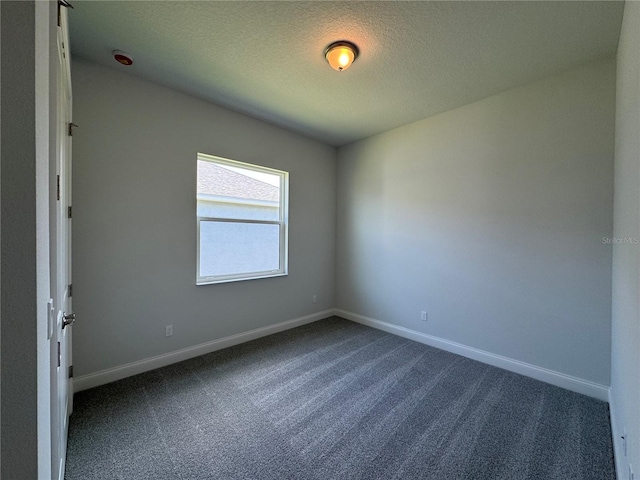 1665 Lake Reserve Dr, Deland, FL 32724 - spare room with dark carpet, baseboards, and a textured ceiling
