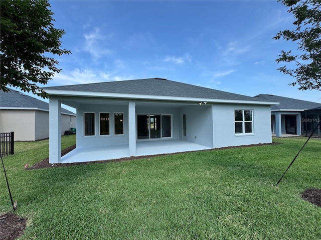 1665 Lake Reserve Dr, Deland, FL 32724 - rear view of property featuring stucco siding, a patio area, and a yard