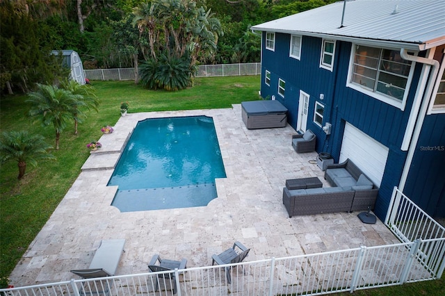 view of pool with a hot tub, a fenced backyard, an outdoor structure, a lawn, and a patio