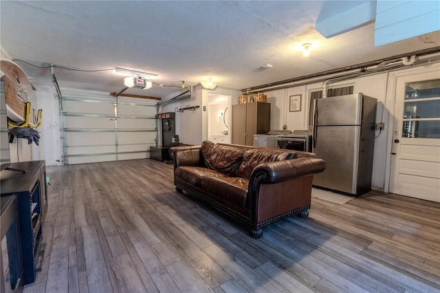 garage featuring a garage door opener and freestanding refrigerator
