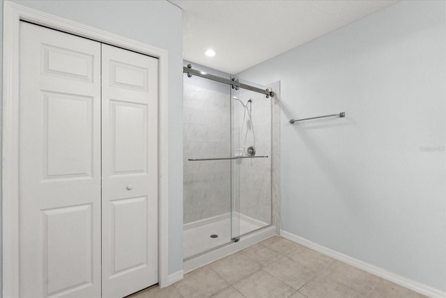 full bath with baseboards, a stall shower, tile patterned flooring, a closet, and recessed lighting