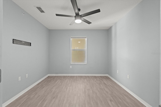 spare room with ceiling fan, wood finished floors, and baseboards