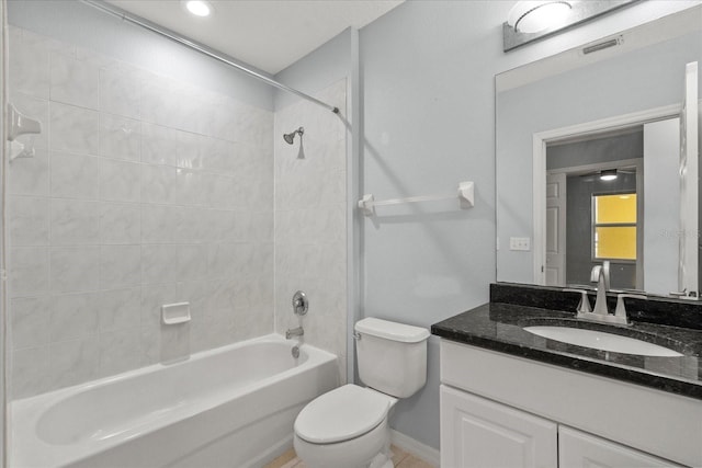 bathroom featuring shower / bath combination, toilet, vanity, and baseboards