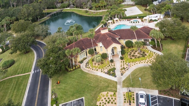 aerial view of property's location with a nearby body of water and a pool