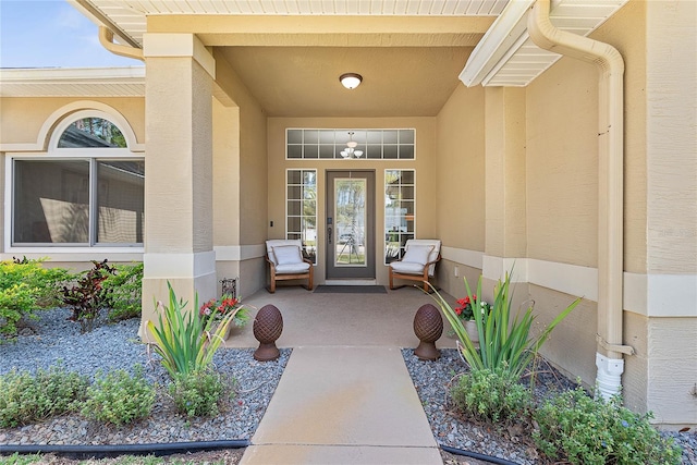 65 Esperanto Dr, Palm Coast, FL 32164 - view of exterior entry featuring stucco siding and covered porch