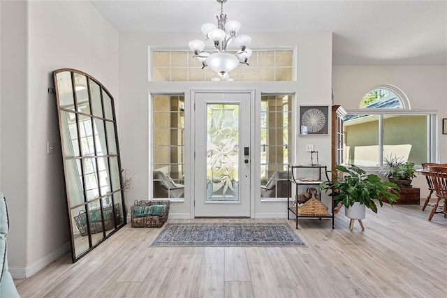 65 Esperanto Dr, Palm Coast, FL 32164 - entrance foyer featuring baseboards, wood finished floors, and an inviting chandelier