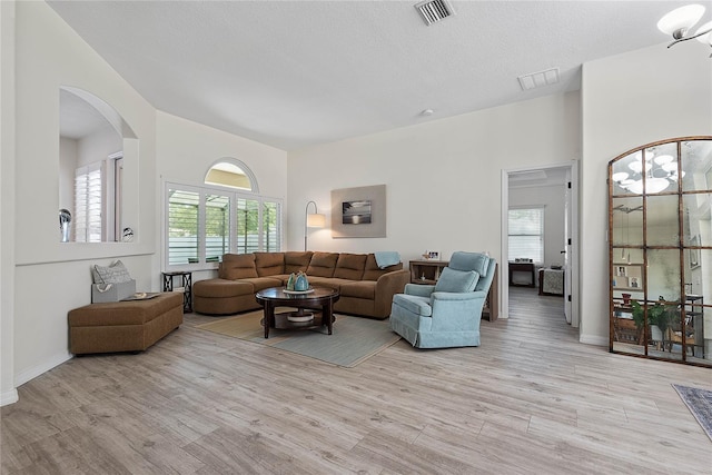 65 Esperanto Dr, Palm Coast, FL 32164 - living area with baseboards, visible vents, arched walkways, and light wood-style floors