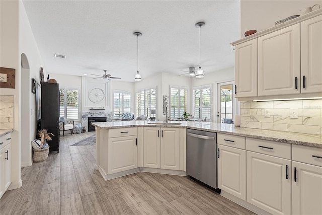 65 Esperanto Dr, Palm Coast, FL 32164 - kitchen with a peninsula, dishwasher, a ceiling fan, and a sink